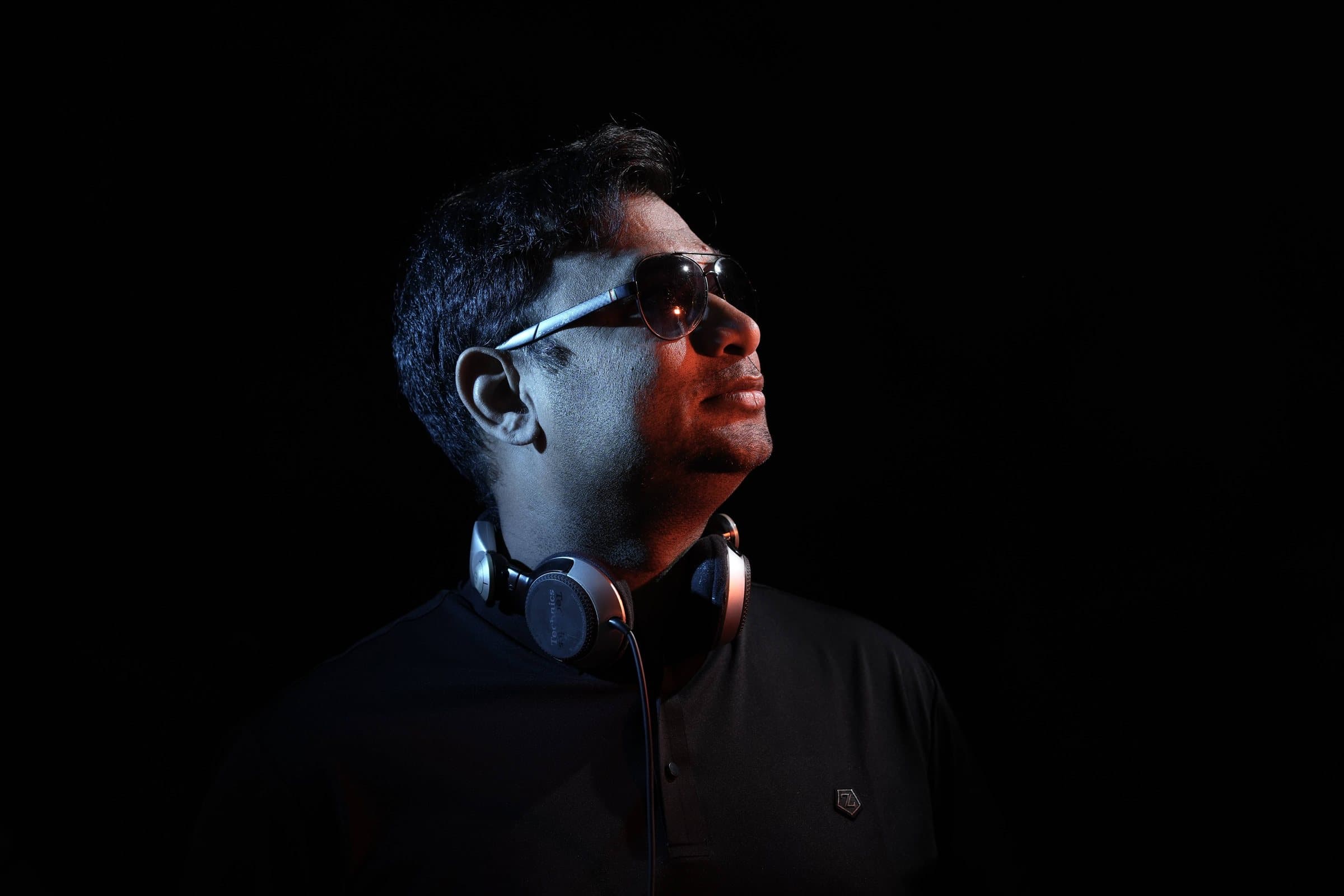 DJ Abdul in right profile with headphones
